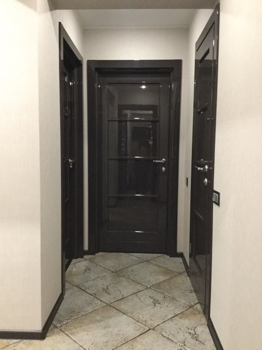 Светлый коридор с темными дверьми